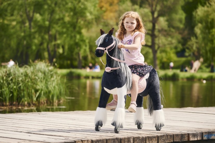 Cheval à roulettes inline Ponnie Domino M avec une selle rose